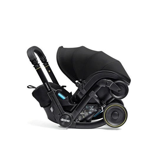 Doona X infant car seat in Nitro Black with the wheels folded away